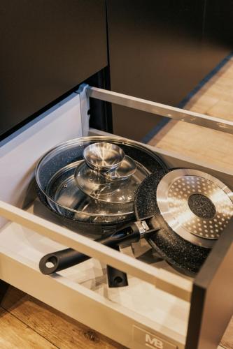 a tray of utensils on a shelf in a kitchen at Apartament Loft in Prudnik