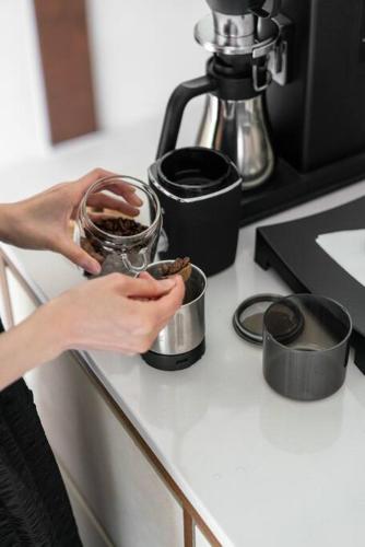 a person holding a cup on top of a counter at Stay pervade in Andong