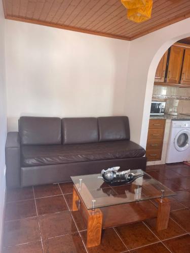 a living room with a couch and a coffee table at Casa mãe in Lajes do Pico