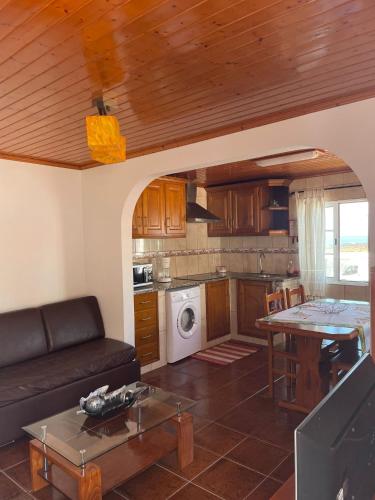 a living room with a couch and a table at Casa mãe in Lajes do Pico
