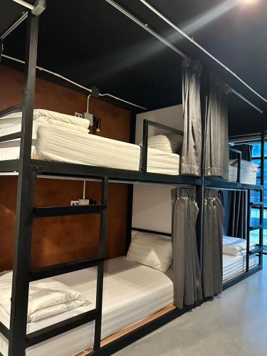 a bunk bed room with three bunk beds at New Warm Light Hostel in Chiang Mai