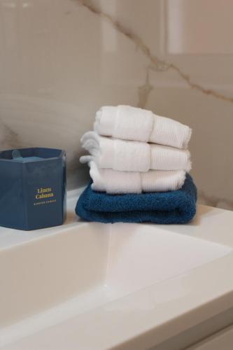 a stack of towels sitting on a table in a bathroom at B&B Blue Luxury Suite in Avellino