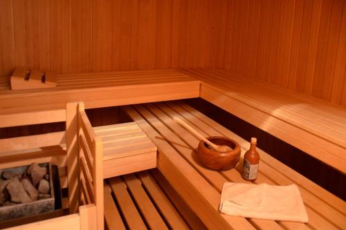 a inside of a sauna with a bottle of alcohol at Gut Basthorst in Basthorst