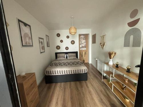 a bedroom with a bed and a wooden floor at A&M Games and spa in Charleville-Mézières