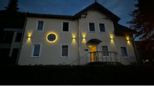 a large white house with lights on it at night at AR Apartments - 1898 in Coburg