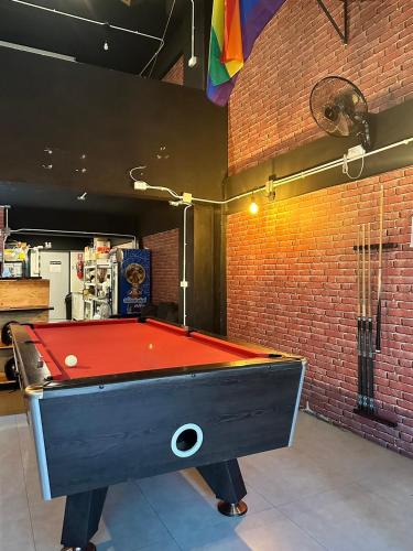a pool table with a red top in a room at New Warm Light Hostel in Chiang Mai