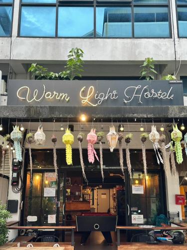 a restaurant with a sign that reads warm light tacos at New Warm Light Hostel in Chiang Mai