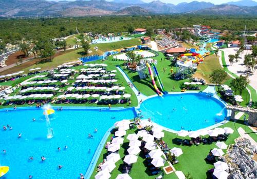 an aerial view of a resort with two pools and umbrellas at Relax Apartments Trebinje in Trebinje