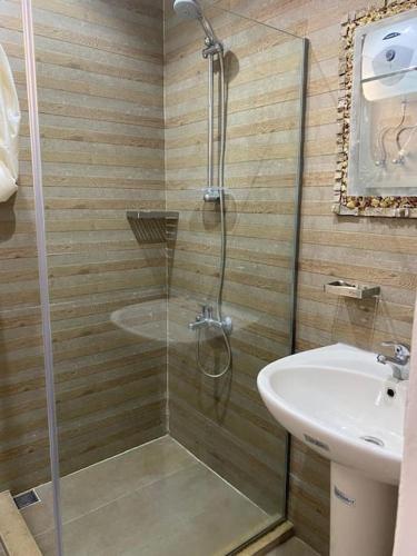 a bathroom with a shower and a sink at Blue Waves Villa Ras Al Hikma in Marsa Matruh