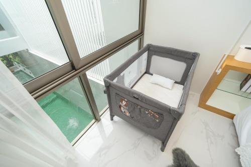 an open room with a bed and a window at Andaman Villa 15 minutes from Bangtao Beach in Phuket Town