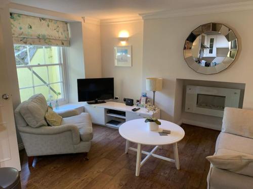 a living room with a couch and a table at One bed flat close to Exeter centre in Exeter