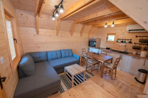 a living room with a blue couch and a table at Etno House Markovic in Kolašin