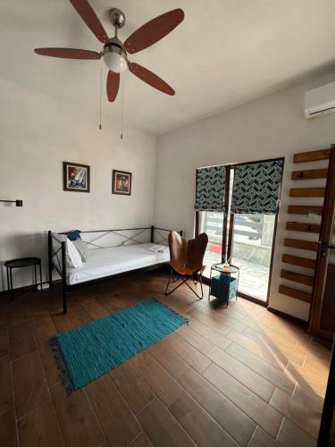 a bedroom with a bed and a ceiling fan at Guest House Kalina,Studio 3 in Ammouliani