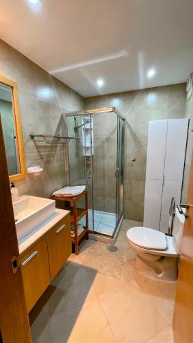 a bathroom with a shower and a toilet and a sink at Golf View Apartment in Sucina