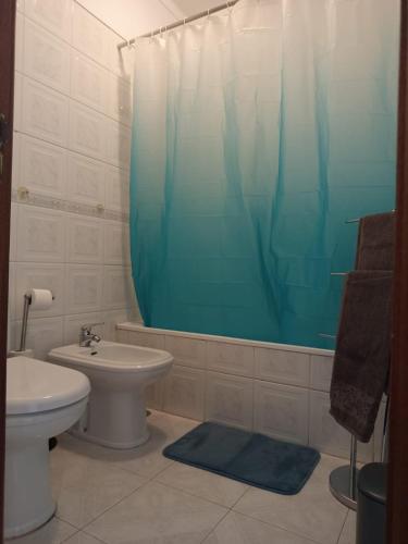 a bathroom with a sink and a toilet and a shower at Tavira sweet home in Tavira