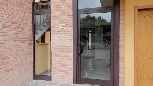 a pair of glass doors on a brick building at La terrazza di Maja in Chieti