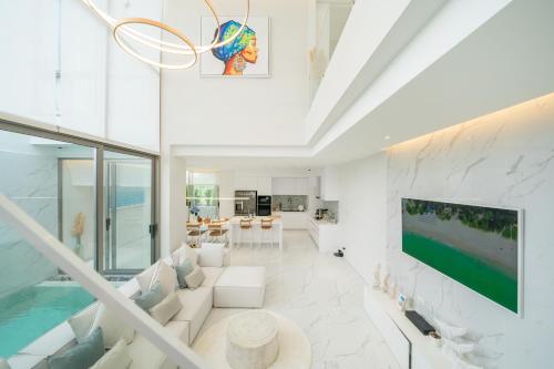 a living room with a pool and a tv at Andaman Villa 15 minutes from Bangtao Beach in Phuket Town