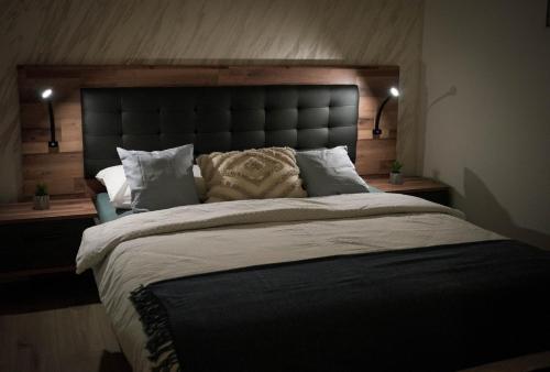 a bedroom with a large bed with a large headboard at Apartman Marijana in Bjelovar