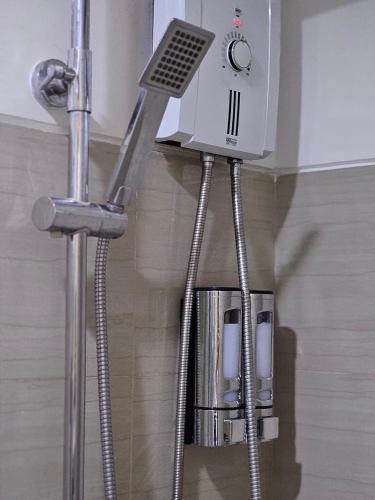 a water heater is hanging from a wall in a bathroom at Q Workcation WFH Staycation in Manila