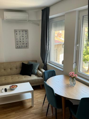 un soggiorno con un divano e un tavolo di NN Apartment 2 a Skopje