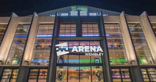 a building with a sign on the front of it at Exclusive London Apartment - Wembley Stadium, OVO Wembley Arena in London