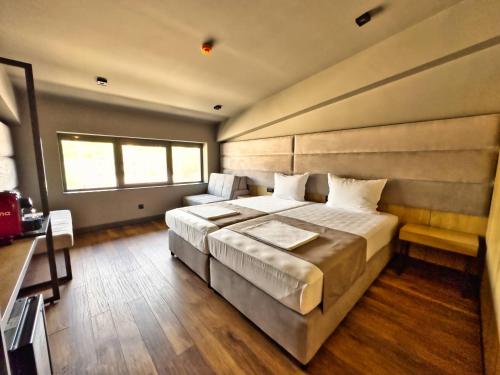 Ένα ή περισσότερα κρεβάτια σε δωμάτιο στο VIGOR Hotel