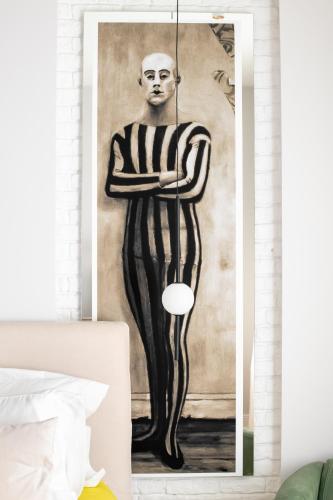 a painting of a man holding a plate at Pop's Apartments in Belgrade