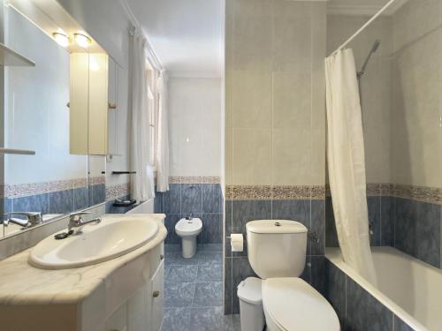 a bathroom with a white toilet and a sink at Miramar - 5710 in Quejo