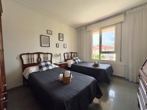 a bedroom with two beds and a window at Miramar - 5710 in Quejo