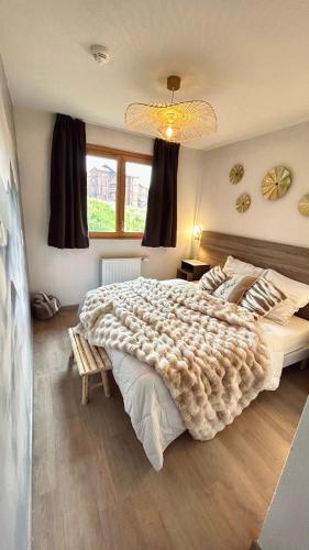 une chambre avec un grand lit et une fenêtre dans l'établissement Crests Lodge - Plagne -Villages 2100m - Classé 4 étoiles, à La Plagne Tarentaise