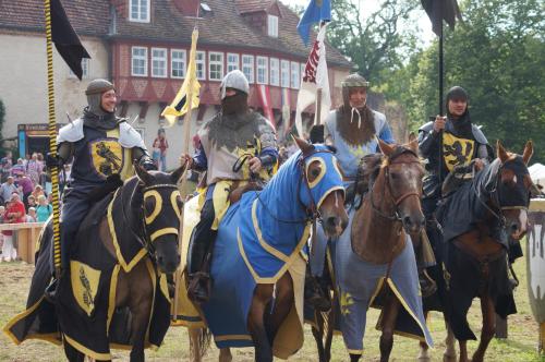 a group of men in medieval armor riding horses at Burghotel Stargard in Burg Stargard
