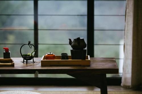 a wooden table with various items on it in front of a window at Hide and see in Sha-p'ing-pa