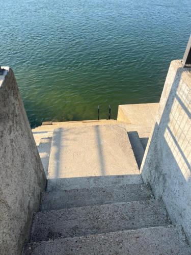 a set of stairs leading down to the water at Apartman na Drini in Loznica