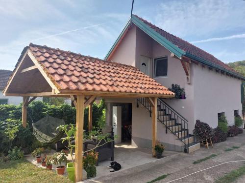 a small white house with a roof at Apartman Dunja Banja Vrdnik in Vrdnik