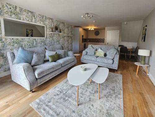 a living room with a couch and a table at Brogans Apartments in Trim