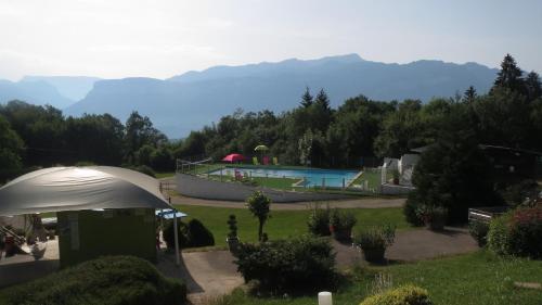 a resort with a swimming pool and a tent at Team Holiday - Camping Le Balcon de Chartreuse in Miribel-les-Échelles