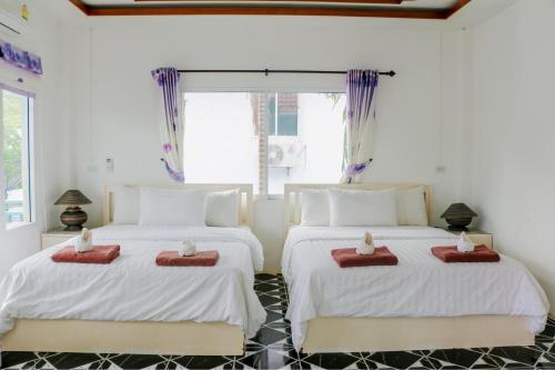 Postel nebo postele na pokoji v ubytování The Light House Resort - Kohlarn เดอะไลท์เฮ้าส์รีสอร์ท เกาะล้าน