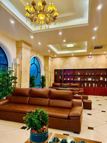 a large lobby with a couch and a wine cellar at Sunrise Hanoi Hotel in Hanoi