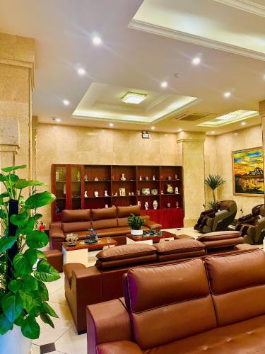 a large room with couches and chairs in a room at Sunrise Hanoi Hotel in Hanoi