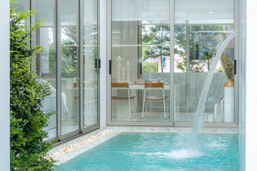 a swimming pool with a fountain in a house at Andaman Villa 15 minutes from Bangtao Beach in Phuket Town