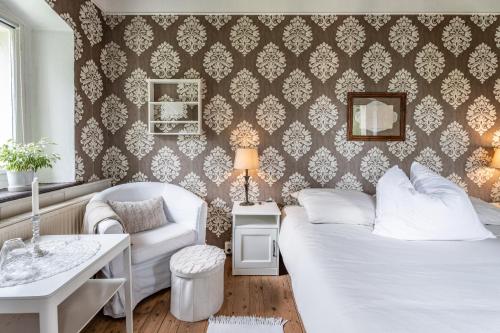 a bedroom with a bed and a couch and a table at Staveni 1818 in Heřmanice
