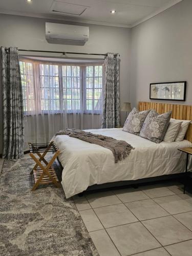 a bedroom with a large bed in front of a window at Marilyn's Cottage in White River