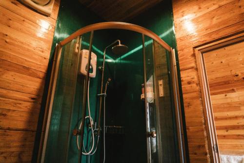 a shower with a glass door in a bathroom at Phumork Camp Phu Chi Fa in Ban Huai Han
