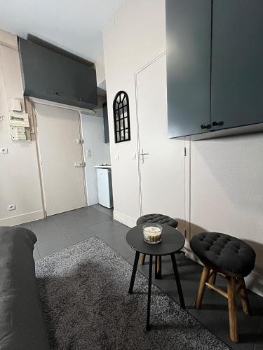 a living room with a couch and a table at Studio cosy Ermont in Ermont