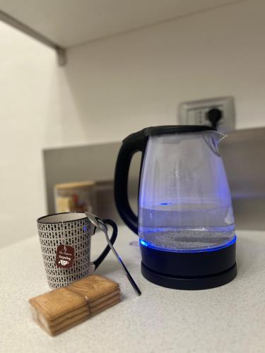 a tea kettle and a cup on a counter at TEZONE SEVEN Apartments in Verona