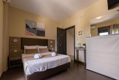 a bedroom with a bed with two towels on it at Sole A Mare in Neos Marmaras