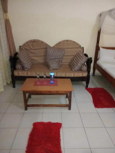 a living room with a couch and a coffee table at One World Apartments in Mombasa