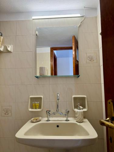 a bathroom with a sink and a mirror at Onar Seaview Apartment in Pythagorio in Pythagoreio