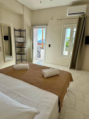 a bedroom with a large bed with two pillows on it at Onar Seaview Apartment in Pythagorio in Pythagoreio