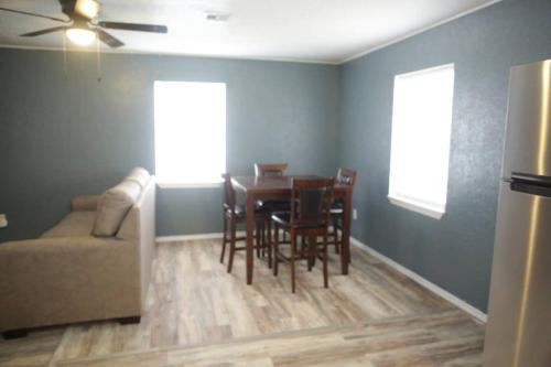 a living room with a table and chairs and a couch at 1 bedroom with a fireplace close to base in Lawton
